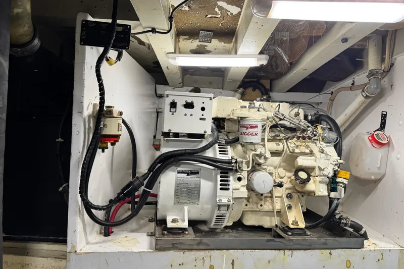 Slide: The Image of Engine room of a 1918 Peterson Tugboat, featuring mechanical components and wiring. - 14