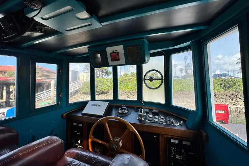 Slide: The Image of Interior of a 1918 Peterson Tugboat with vintage steering wheel and control panel. - 19