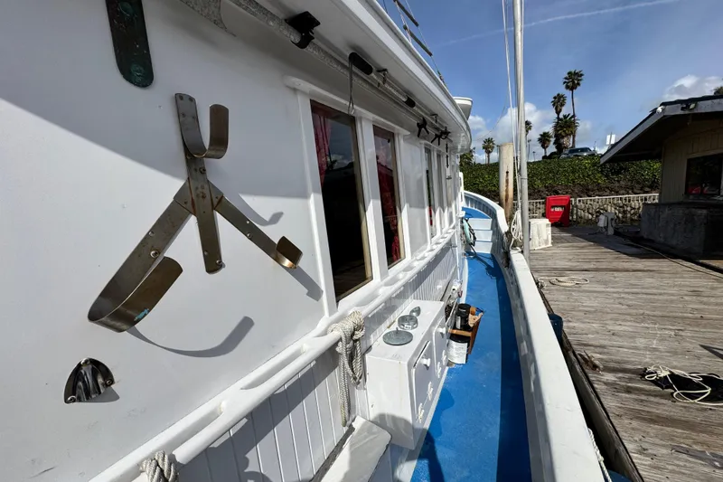 Slide: The Image of Historic 1918 Peterson Tugboat docked, showcasing nautical details and vibrant blue deck. - 21
