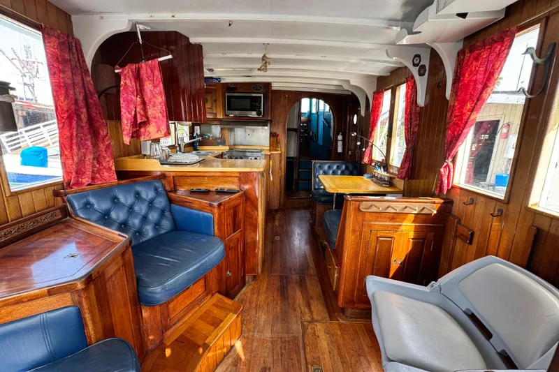 Slide: The Image of Interior of a 1918 Peterson Tugboat with wood paneling and vintage furnishings. - 3