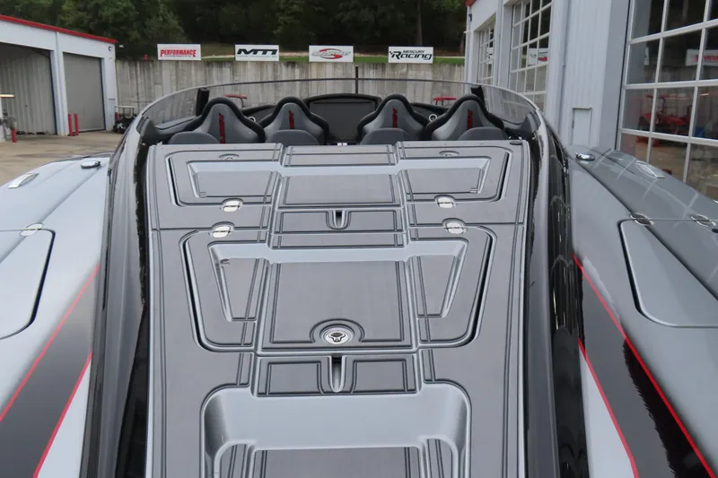 Slide: The Image of 2025 MTI 390X boat with sleek design and modern seating at a marina. - 11