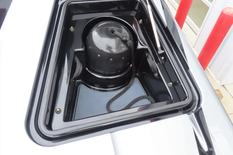 Slide: The Image of MTI 390X 2025 model storage compartment with black interior and rope. - 13