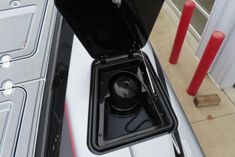 Slide: The Image of Open storage compartment on 2025 MTI 390X boat, showcasing interior details. - 14