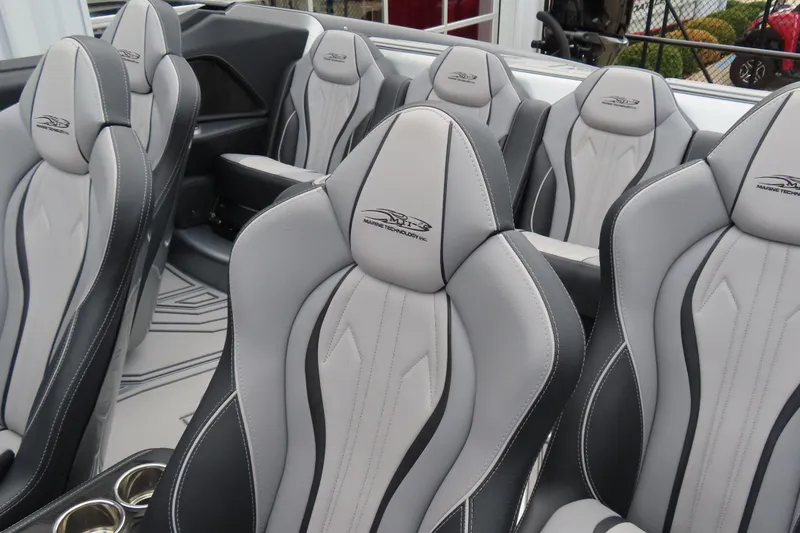 Slide: The Image of Luxurious interior seating of 2025 MTI 390X boat with sleek gray and black design. - 25