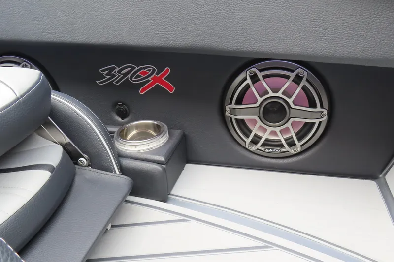 Slide: The Image of 2025 MTI 390X boat interior with speaker and cup holder. - 26