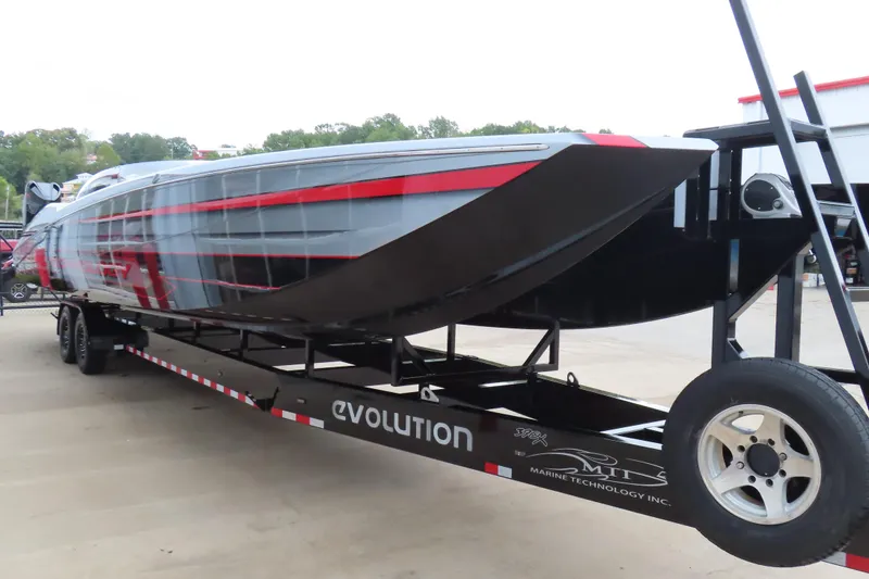 Slide: The Image of 2025 MTI 390X powerboat on trailer, sleek design with red and black accents. - 28