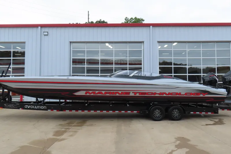 Slide: The Image of 2025 MTI 390X powerboat on trailer outside a modern garage. - 3