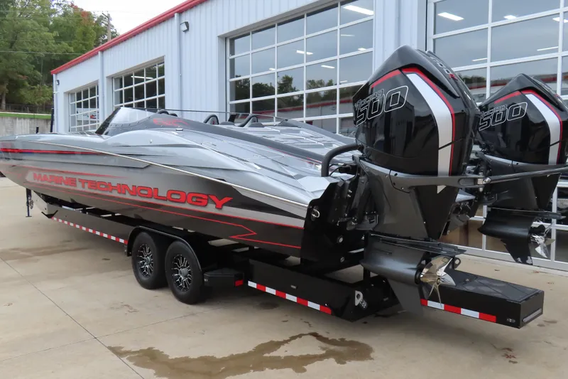 Slide: The Image of 2025 MTI 390X powerboat with dual 500 engines, parked outside a modern garage. - 4