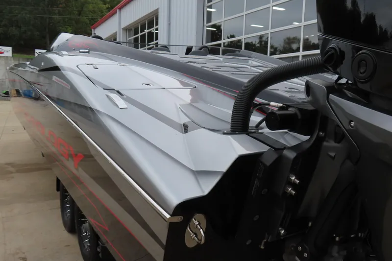 Slide: The Image of 2025 MTI 390X boat, sleek design, parked near a modern building. - 6