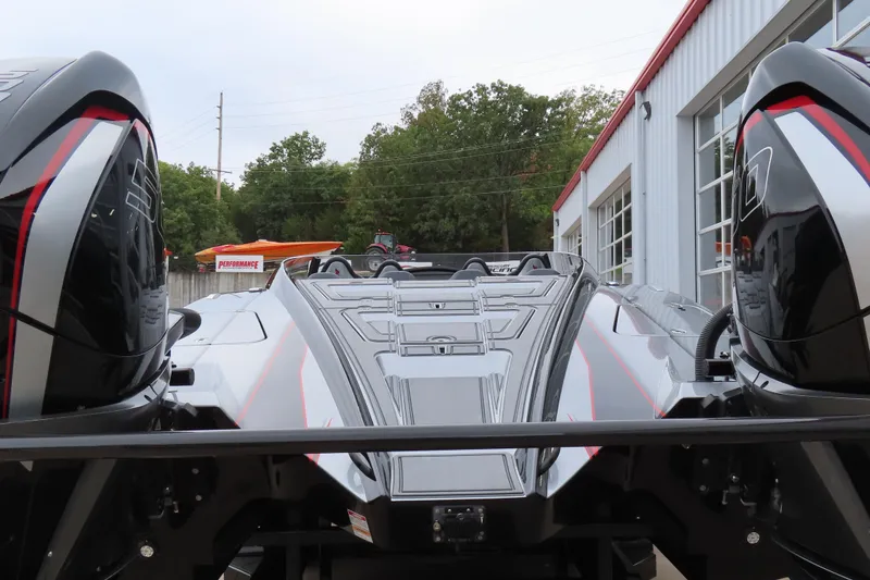 Slide: The Image of 2025 MTI 390X powerboat with sleek design, parked outside a garage. - 7