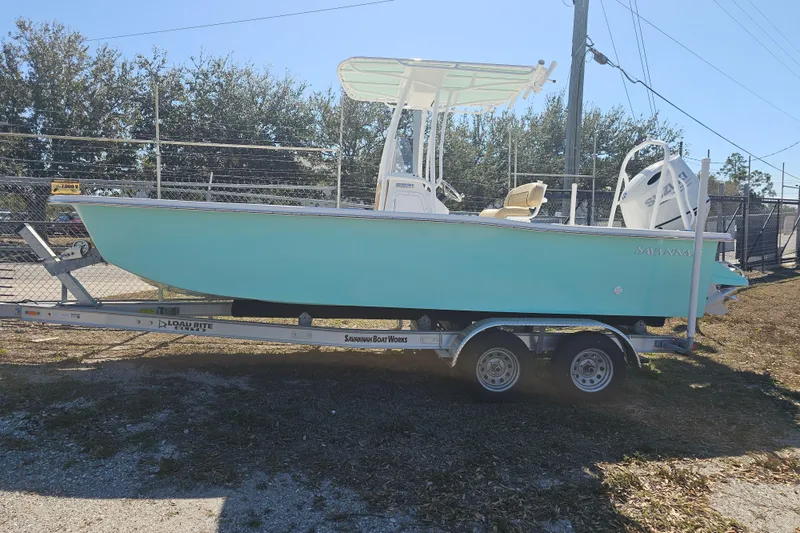 The Image of 2025 Savannah SS21 boat on trailer, light blue hull, parked outdoors. - 0