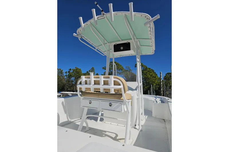 Slide: The Image of 2025 Savannah SS21 boat with T-top and rod holders under clear blue sky. - 3