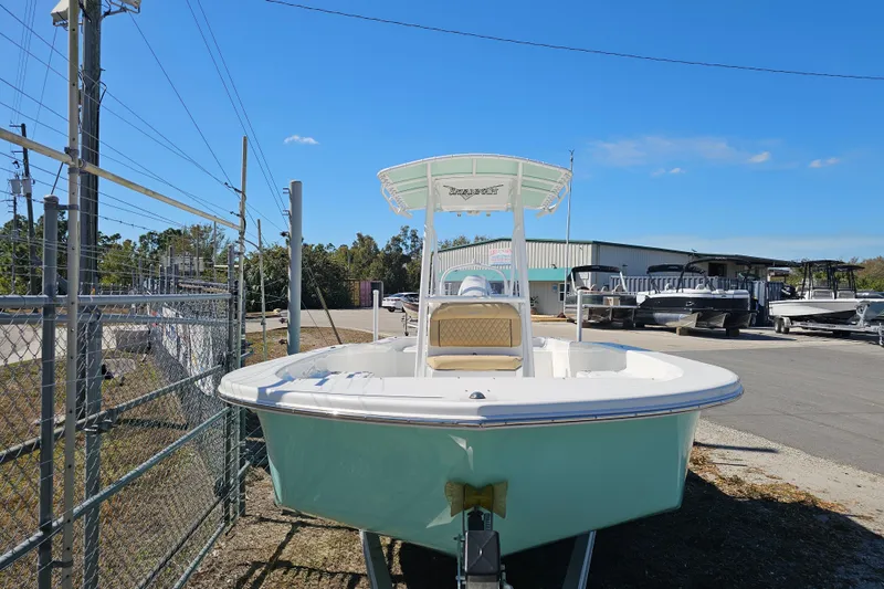 Slide: The Image of 2025 Savannah SS21 boat on trailer at dealership under clear blue sky. - 7
