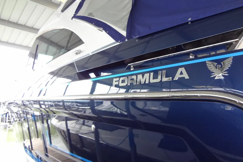 Slide: The Image of 2023 Formula 380 Super Sport Crossover I/O boat, sleek design under covered dock. - 19