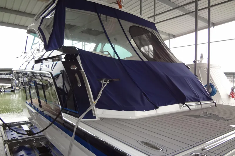 Slide: The Image of 2023 Formula 380 Super Sport Crossover I/O docked under a covered marina. - 20