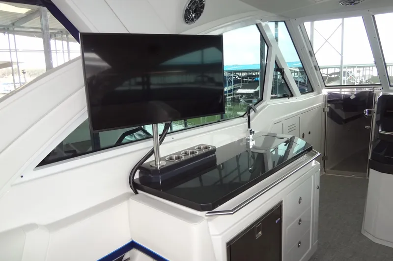 Slide: The Image of Interior of 2023 Formula 380 Super Sport Crossover I/O with TV and sleek cabinetry. - 30