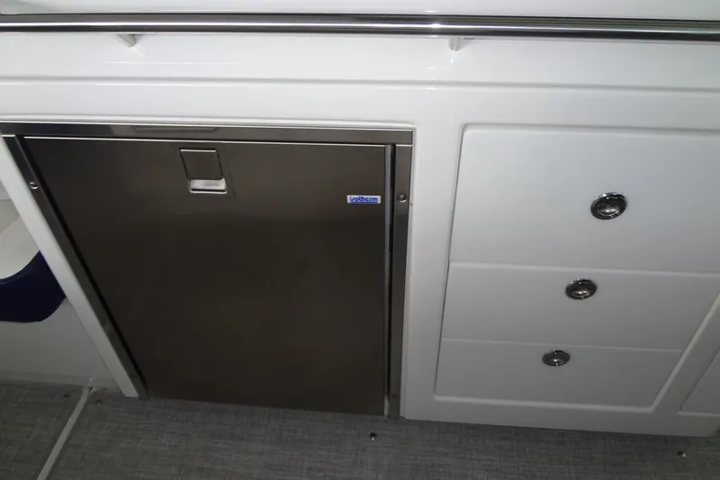 Slide: The Image of 2023 Formula 380 Super Sport Crossover I/O interior with stainless steel fridge and storage drawers. - 33