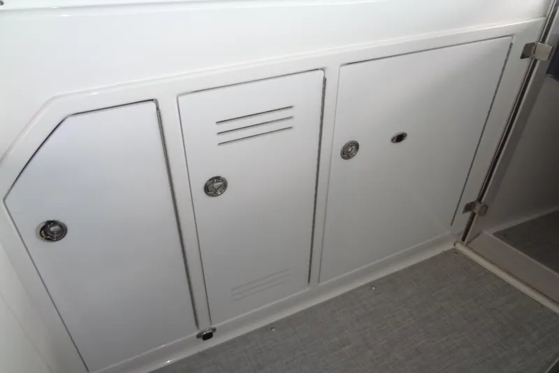 Slide: The Image of 2023 Formula 380 Super Sport Crossover I/O boat interior with white seating and speakers. - 41