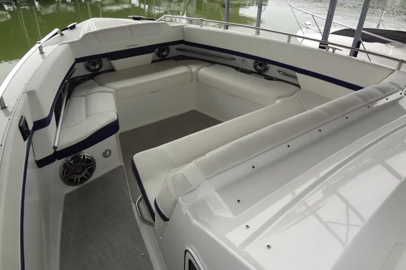 Slide: The Image of 2023 Formula 380 Super Sport Crossover I/O boat interior with white seating and sleek design. - 42