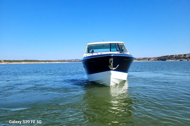 Slide: The Image of 2023 Formula 380 Super Sport Crossover I/O cruising on a sunny lake. - 5