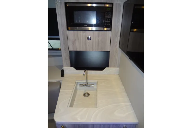 Slide: The Image of 2023 Formula 380 Super Sport Crossover interior with microwave and flat-screen TV. - 54