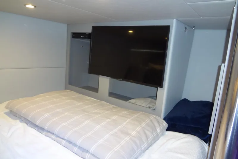 Slide: The Image of 2023 Formula 380 Super Sport Crossover I/O cabin interior with modern design and cozy bedding. - 58