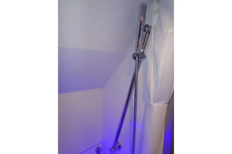 Slide: The Image of 2023 Formula 380 Super Sport Crossover I/O interior with white seating and blue LED lighting. - 61