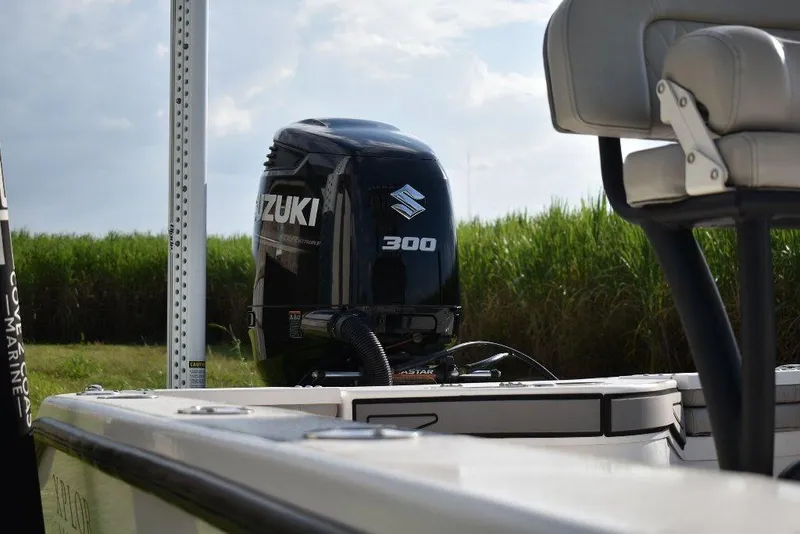 Slide: The Image of 2023 Xplor X24 boat with Suzuki 300 outboard motor in scenic outdoor setting. - 10
