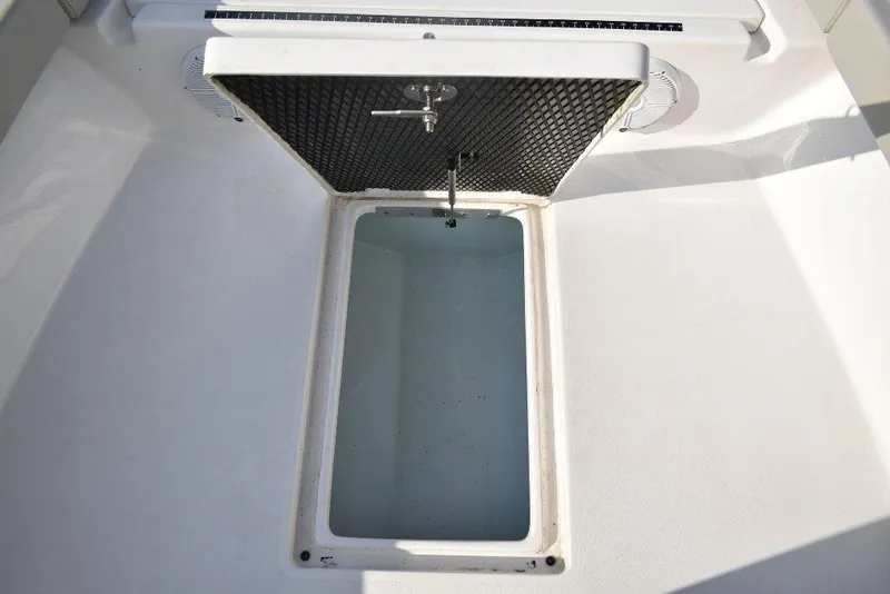 Slide: The Image of Open storage compartment on 2023 Xplor X24 boat, featuring a spacious interior. - 11