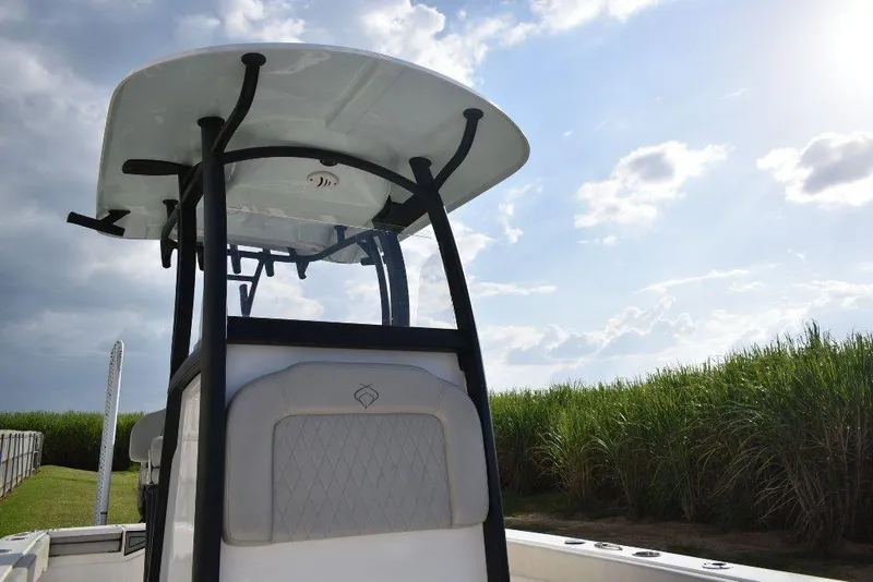 Slide: The Image of 2023 Xplor X24 boat with T-top against a cloudy sky backdrop. - 12