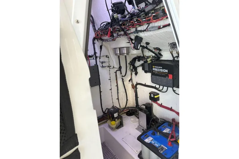 Slide: The Image of Electrical system setup inside 2023 Xplor X24 boat, featuring batteries and wiring. - 14