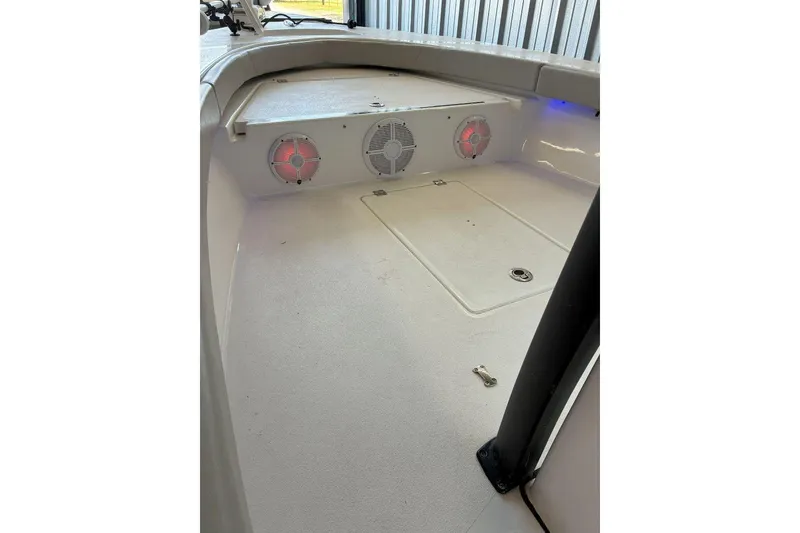 Slide: The Image of 2023 Xplor X24 boat interior with speakers and storage compartment. - 17
