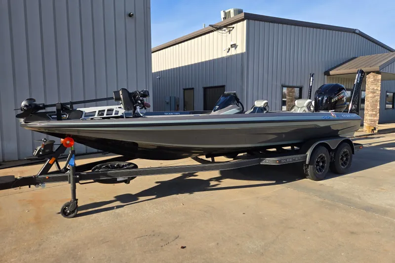 Slide: The Image of 2026 Skeeter ZXE21 boat on trailer, parked outside a building. - 32