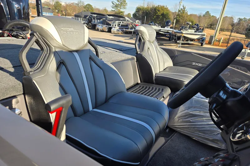 Slide: The Image of 2026 Skeeter ZXE21 boat interior with sleek, modern seating and steering wheel. - 39