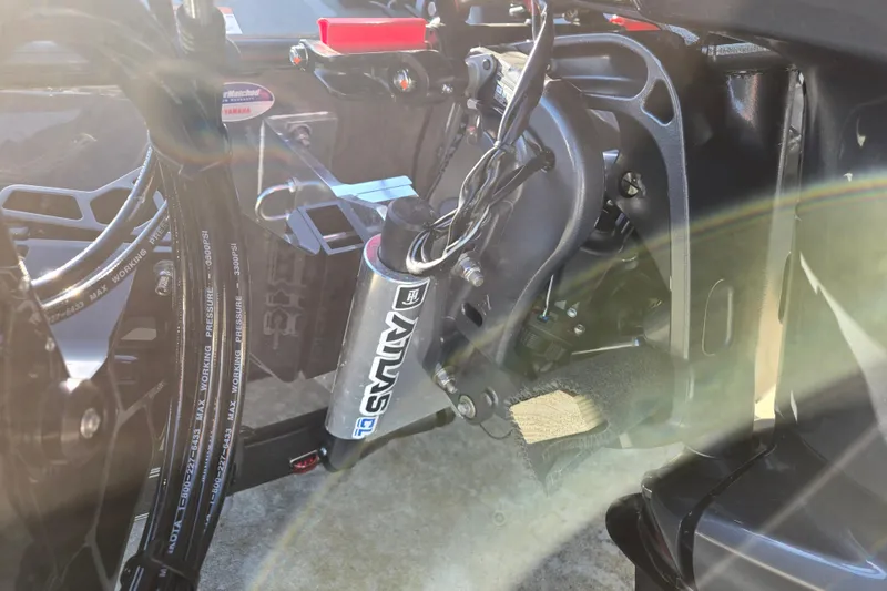 Slide: The Image of Close-up of 2026 Skeeter ZXE21 boat engine components with visible wiring and hydraulic system. - 44