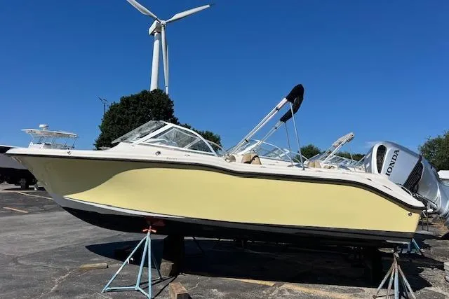 Slide: The Image of 2020 Key West 239 DFS boat on stands, with wind turbine in background. - 2