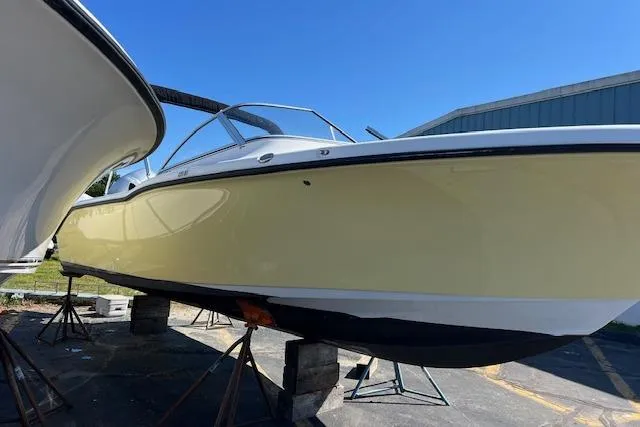 Slide: The Image of 2020 Key West 239 DFS boat on stands, yellow hull, clear blue sky background. - 3