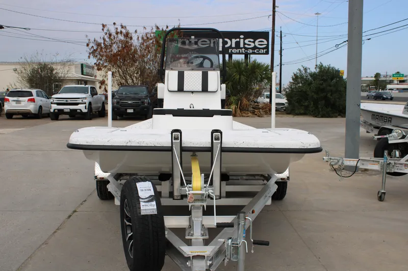 Slide: The Image of 2026 Freedom Boats 16' Eagle on trailer, parked in a lot with cars and trees. - 13