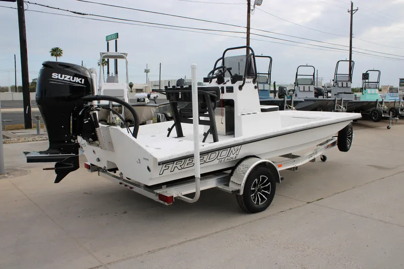 Slide: The Image of 2026 Freedom Boats 16' Eagle with Suzuki outboard motor on trailer. - 2