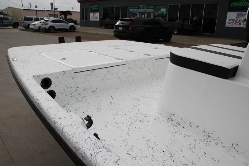 Slide: The Image of 2026 Freedom Boats 16' Eagle with speckled deck, parked outside dealership. - 14