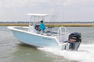 Slide: The Image of 2020 Sportsman Heritage 231 Center Console boat dashboard with steering wheel and controls. - 11