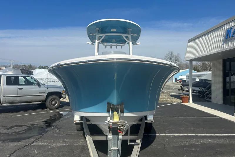Slide: The Image of 2020 Sportsman Heritage 231 Center Console boat on trailer, parked outside dealership. - 2