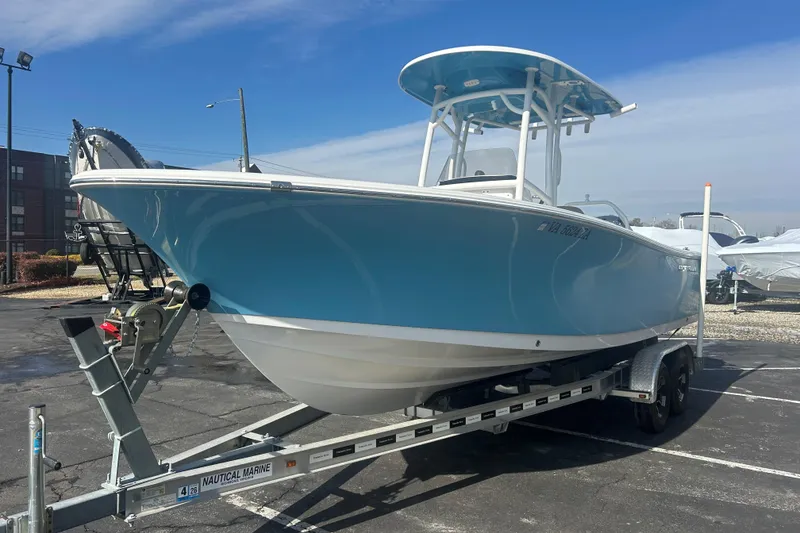 Slide: The Image of 2020 Sportsman Heritage 231 Center Console boat on trailer, parked outdoors. - 3
