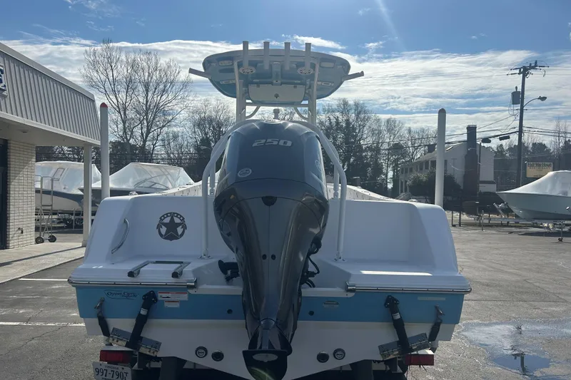 Slide: The Image of 2020 Sportsman Heritage 231 Center Console boat with powerful 250 engine, parked outdoors. - 5