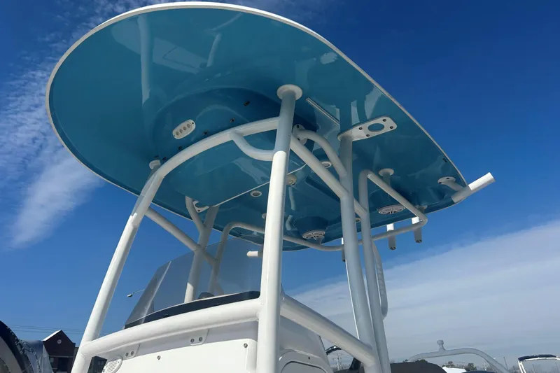 Slide: The Image of 2020 Sportsman Heritage 231 Center Console boat with blue T-top against clear sky. - 7