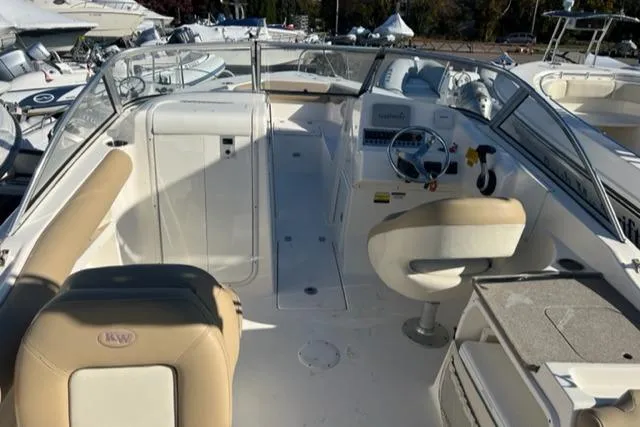Slide: The Image of 2020 Key West 239 DFS boat interior with beige seating and steering console. - 14
