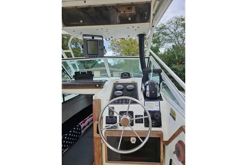 Slide: The Image of 1990 Hydra-Sports Vector 2500 CC boat cockpit with steering wheel and control panel. - 6