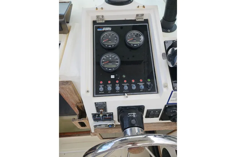 Slide: The Image of 1990 Hydra-Sports Vector 2500 CC boat dashboard with gauges and controls. - 7