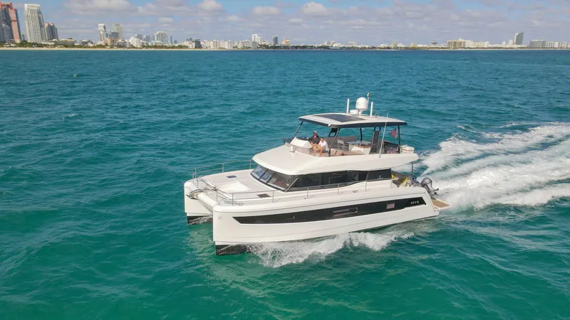 The Image of 2022 Fountaine Pajot MY6 yacht cruising on turquoise ocean near city skyline. - 0