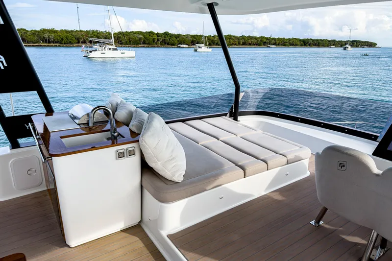 Slide: The Image of Luxurious 2022 Fountaine Pajot MY6 yacht interior with sunbed and ocean view. - 11